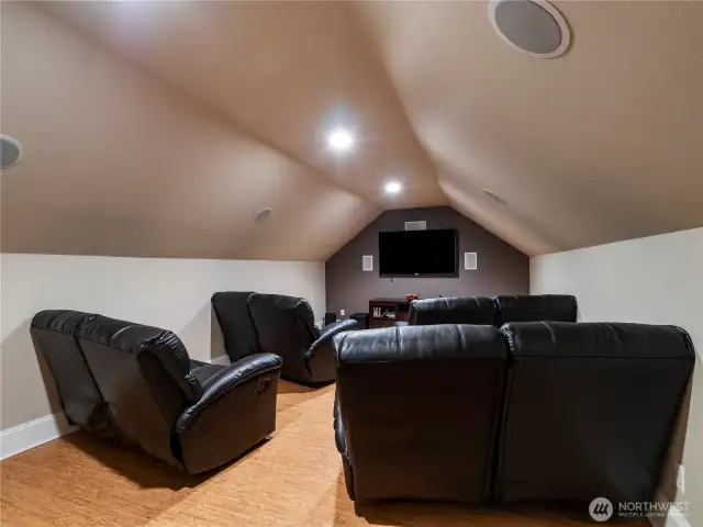 The theater room is ready with a top of the line surround sound system, flat screen tv and comfy recliners!