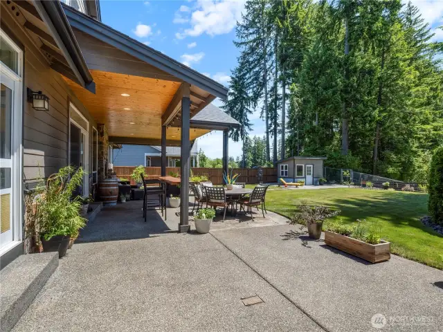 The covered patio with gas fireplace and sound system provides a wonderful space to entertain and enjoy late night dinners and fireside chats.