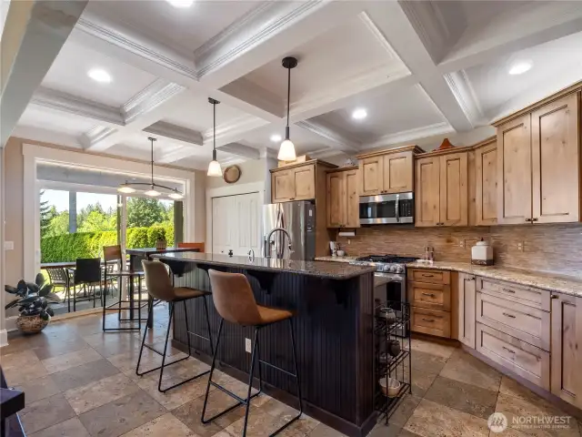 Beautiful wood cabinetry, granite slab counters, stainless steel appliances, gas range and breakfast bar.