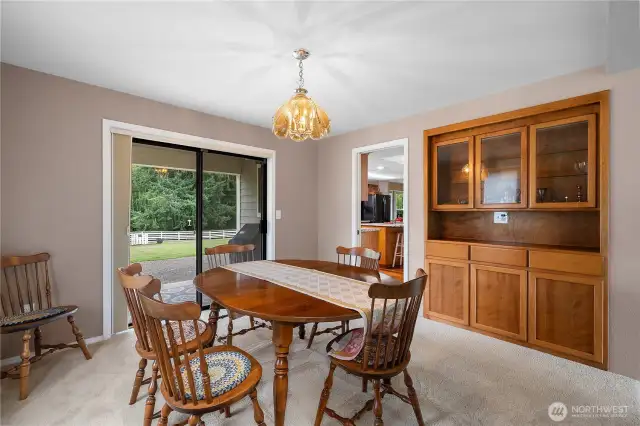 Formal dining room with slider to the back patio area.