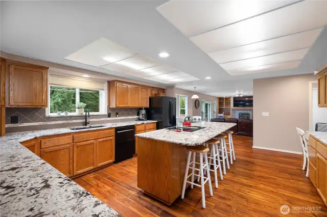 What an amazing kitchen!  Tons of counter space, cabinets and look at the size of that island!!