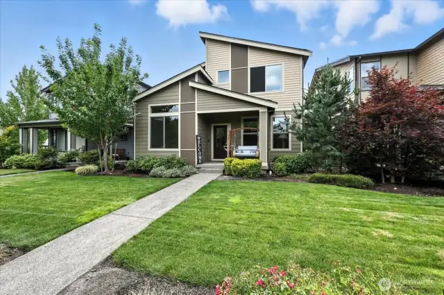 The home's front view faces a serene greenbelt.