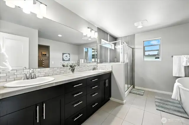 Retreat to a spacious five-piece primary bathroom featuring a luxurious soaking tub, dual vanities, a walk-in-shower, and a private water closet-designed for comfort and relaxation.