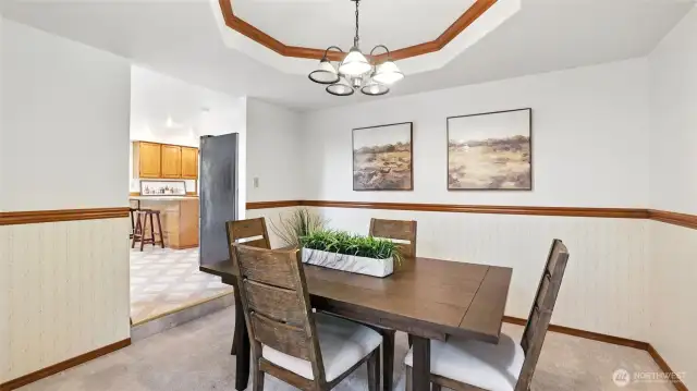 This formal dining space featuring beautiful tray ceiling offers the perfect space for intimate dinners or large gatherings!