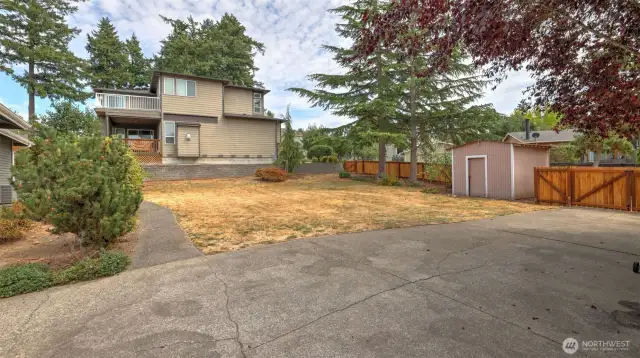 Enjoy this additional parking & large side yard with storage shed!