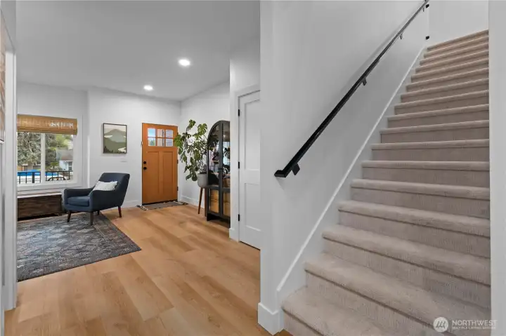 Reverse angle of the entry area and view up the stairs to the upper level private spaces.