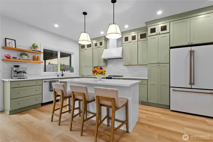 Cafe appliances and solid countertops in the Entertainer's Kitchen.