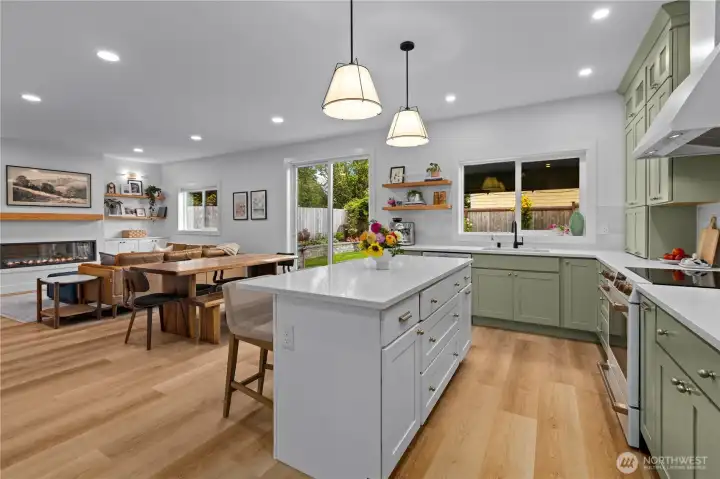 Free standing kitchen island with contrasting cabinetry is the perfect spot for a breakfast bar.
