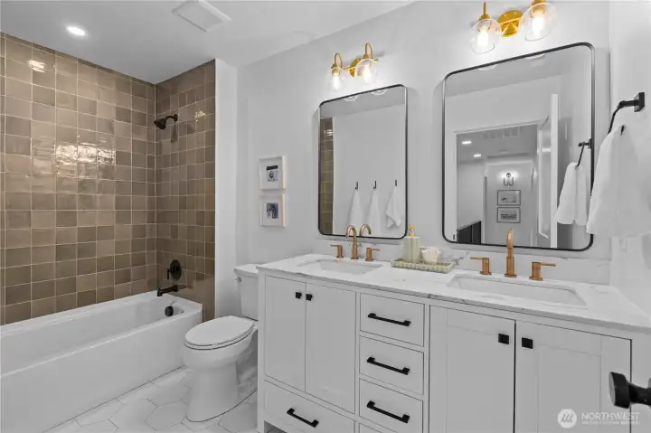 Generously sized second upstairs bathroom services the other three bedrooms. High end cabinets, hardware and lighting.