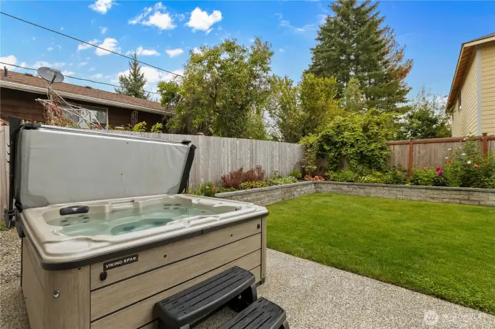 Unwind in the hot tub. Note the hardscaping and thoughtful landscaping.