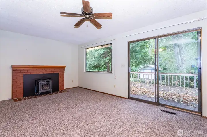 Family room, with propane fireplace insert, slider to spacious rear deck overlooking mature landscaping