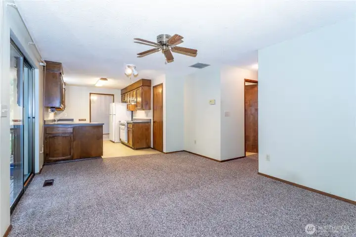 A view from the southside of the family room to the kitchen, at far left, slider to rear patio.