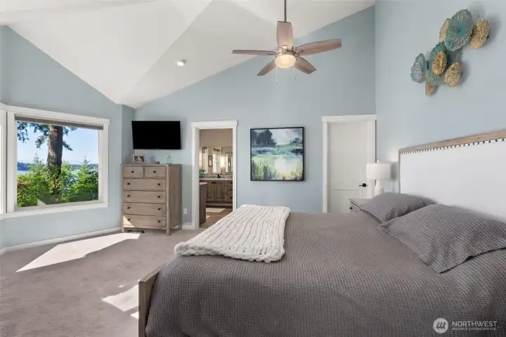 Vaulted ceiling in primary bed, door on the right leads to walk-in closet.