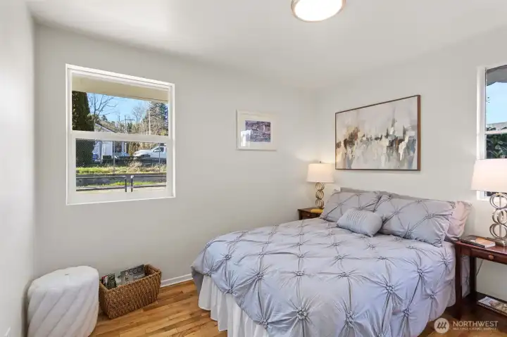 The west-facing back bedroom is filled with afternoon light and features hardwood floors and a comfortable, flexible layout.