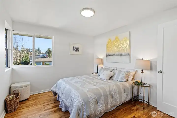 With three windows and a wider footprint than the other bedrooms, the front bedroom offers a notably open and comfortable feel.