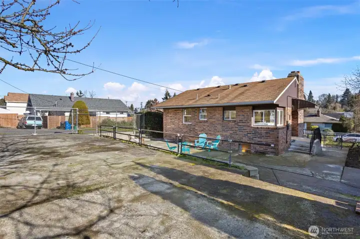 A rear driveway provides generous off-street parking with room for a boat or RV, positioned for privacy away from the alley.