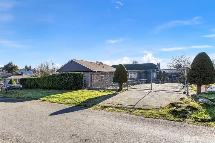 The rear approach highlights the home’s flexible access and separation from the street, reinforcing the benefits of the corner-lot setting.