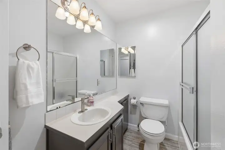 Full Bath features a linen closet and a tankless hot water heater.