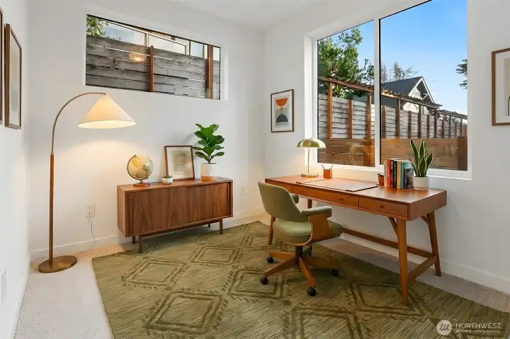 Virtually staged m  ain floor office/den