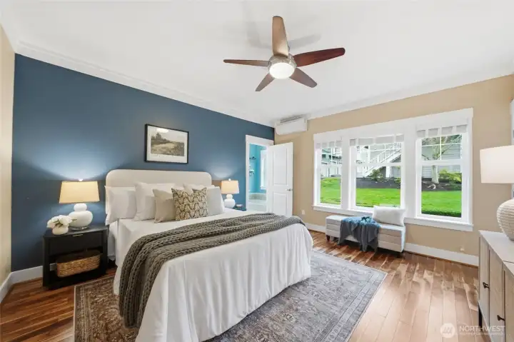 The primary bedroom has a walk-in closet, en-suite bathroom and windows that look out to the back patio.