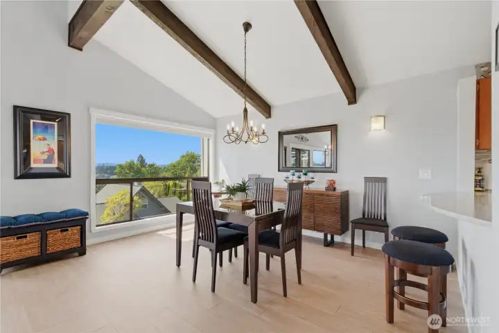 Dining area flows seamlessly into the living room while still feeling like its own defined space—perfect for gathering, with windows that bring in natural light and showcase the view.