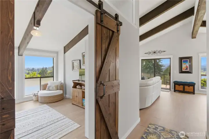Stylish barn doors create a unique entry to the main-level bedroom—adding character while maximizing space and functionality.