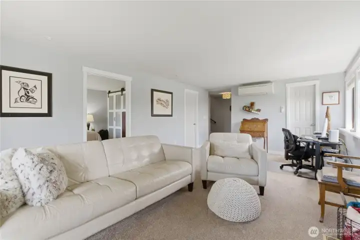 Lower-level living space includes a tucked-away hidden hobby room—perfect for crafts, projects, or extra storage while keeping the main area open and inviting.