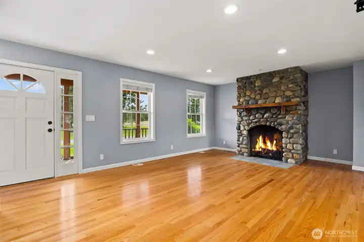 Living Room view to fireplace and entry Living Room view to fireplace and entry