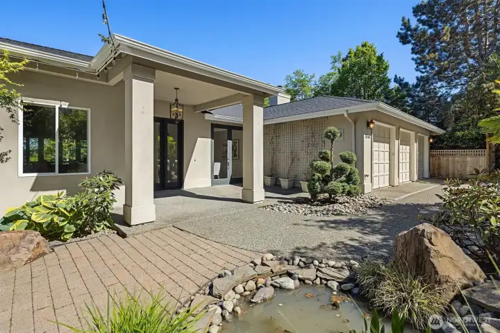 Private courtyard with water feature and pond.