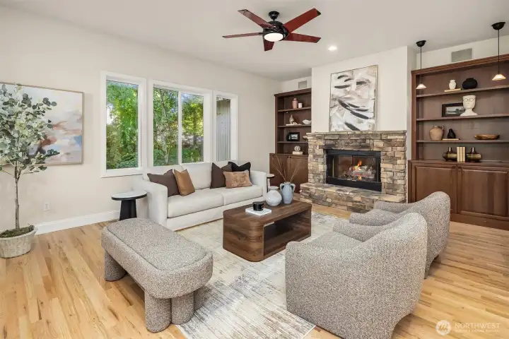 Custom built-ins flank the fireplace. Bookshelves to the left and a bar to the right.