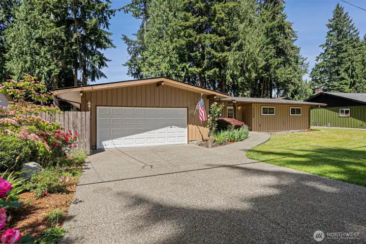 A durable Exposed aggregate driveway and front walk-way entrance, adds to your home's curb appeal and aesthetic charm.