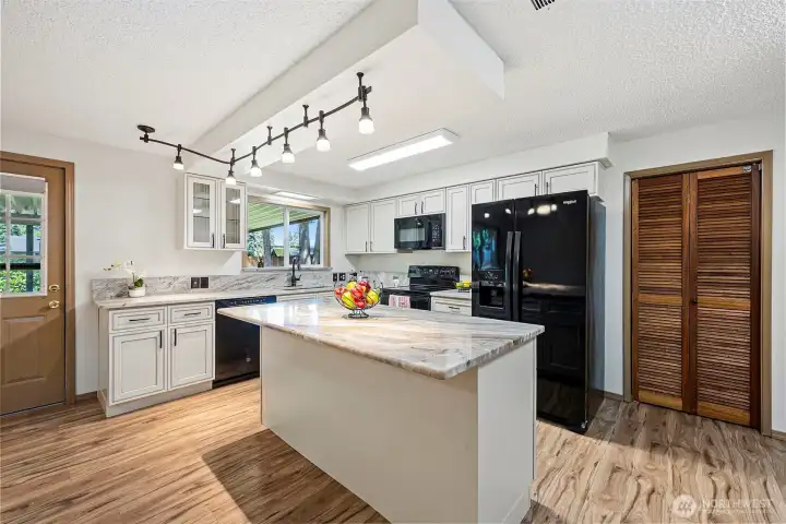 Experience a bright open Kitchen featuring pantry and large island with seating. Perfect for hosting friends or family while you whip up your favorite meals ,