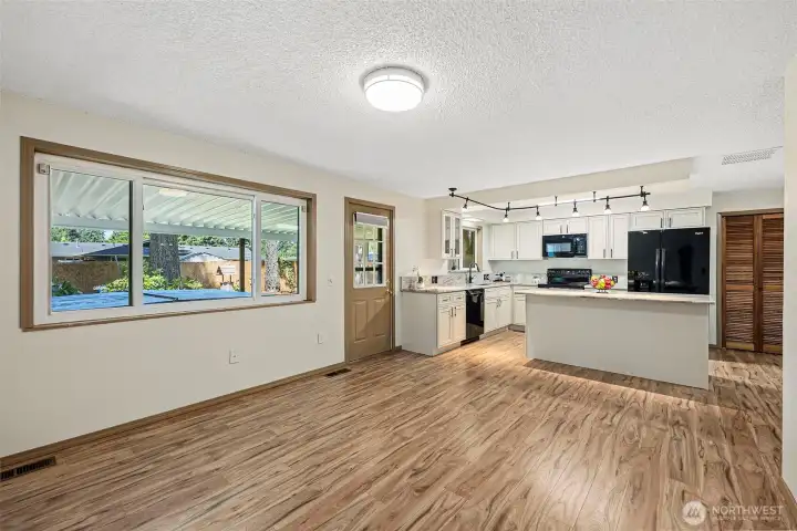 This open kitchen features a central island, that connects to the family room. Step outside to the covered back patio, complete with hot tub and expansive entertaining area, perfect for cooking, grilling and enjoying gatherings througout the year.