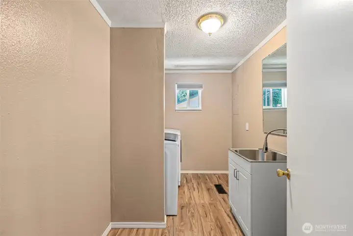 Utility room has convenient 1/2 bath  for easy clean up  and laundry when needed