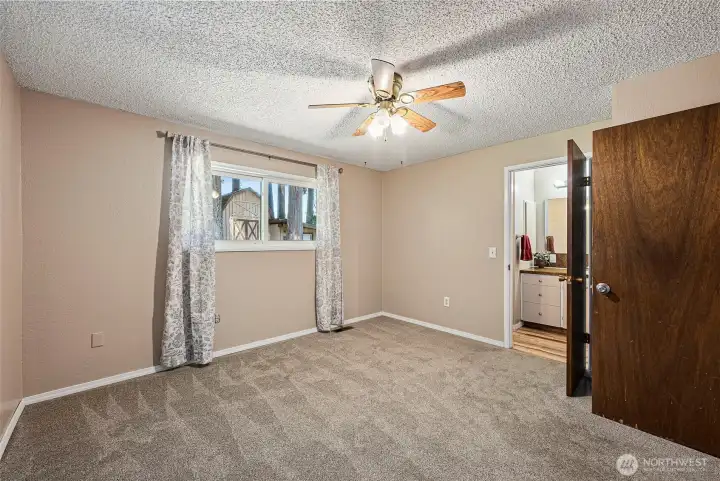 Primary bedroom with ensuite bath and windows looking out to your private back yard