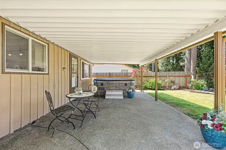 Relax on your covered back patio, complete with a hot tub and ample space for additional dining. It's the ideal spot for unwinding or hosting gatherings. Exposed aggregate patio for long lasting beauty
