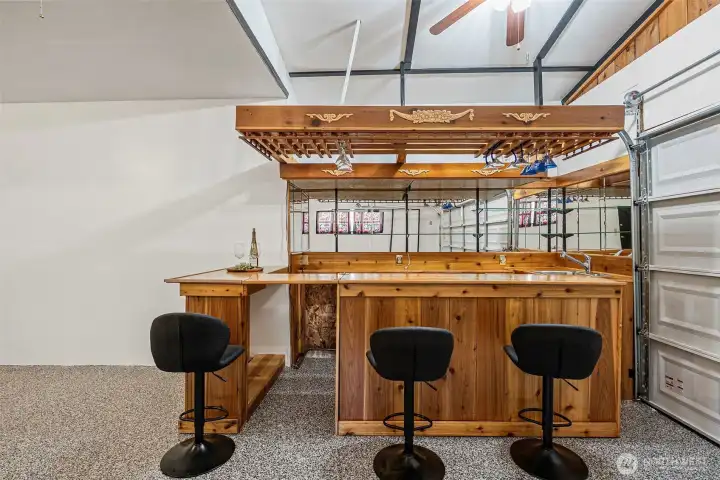 Beautiful custom built cedar bar with seating that is oh so sweet when entertaining