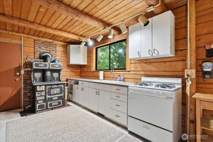 Both a propane range and an eye-catching antique wood-burning cook stove