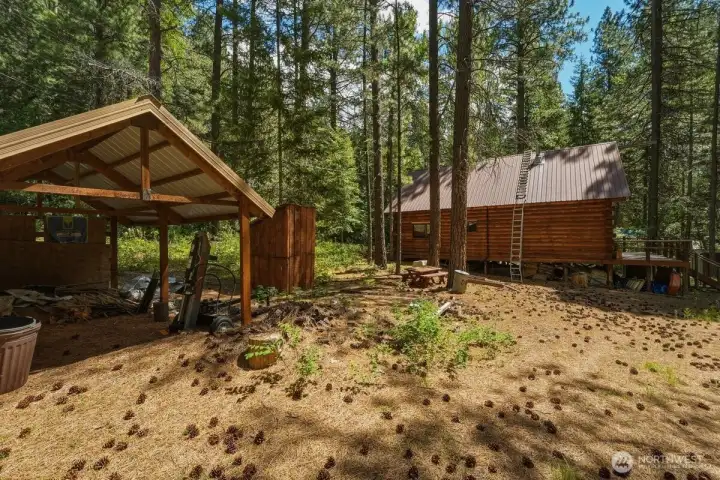 Private well, 300-gallon septic/holding tank, carport, storage shed, and county-maintained road access for year-round convenience