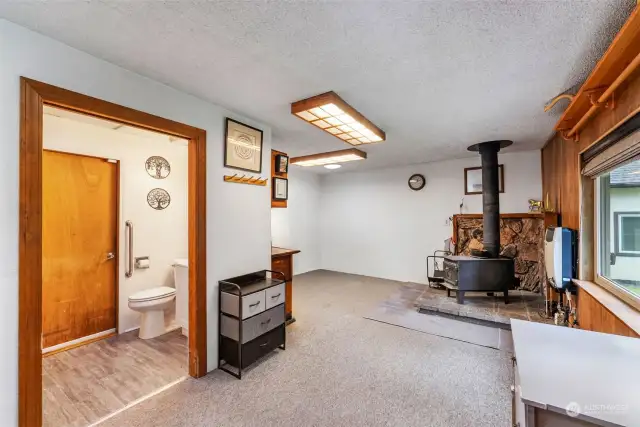 Family room with wood stove and wall heater.  3/4 batth with updated flooring, vanity and fixtures.