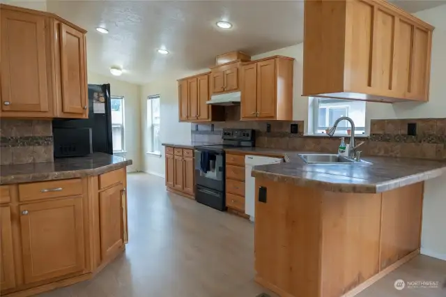 Kitchen with ample amount of counter space and cabinet space for storage.