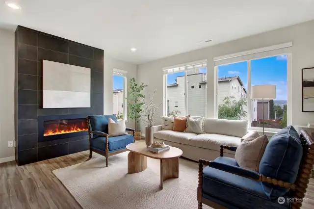 Tall ceilings, large windows and a chic gas fireplace give the living space a comfy and cozy yet stylish vibe.