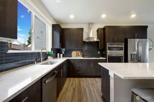 Sleek stainless appliances, quartz counters and gas cooking!