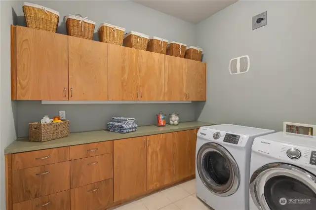 As a former model home, the laundry room is bigger than other units, with great cabinet storage