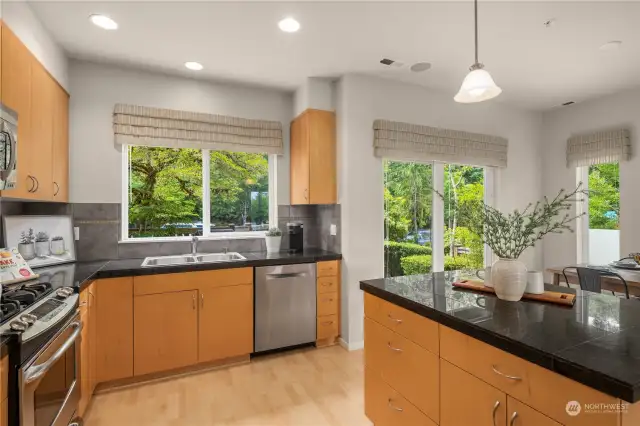Stainless steel appliances, granite countertops and lots of storage space. The kitchen /dining area, and patio overlook the lush protected green space across the street.