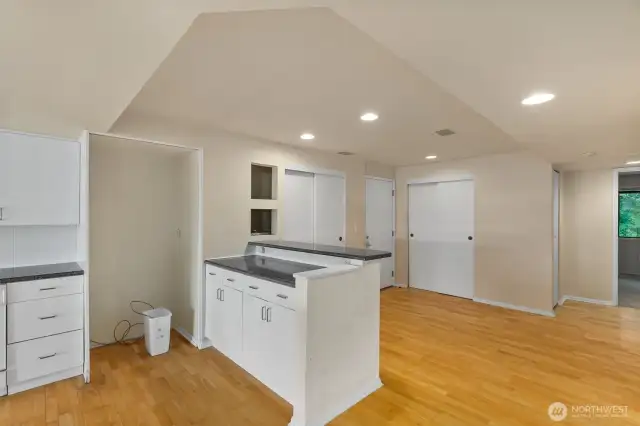 Hard surface floors inside the entry with coat closet, kitchen pantry and eating space