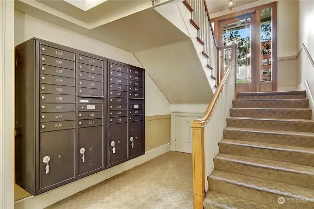 Modern mailboxes on the first floor across from laundry and bike storage.