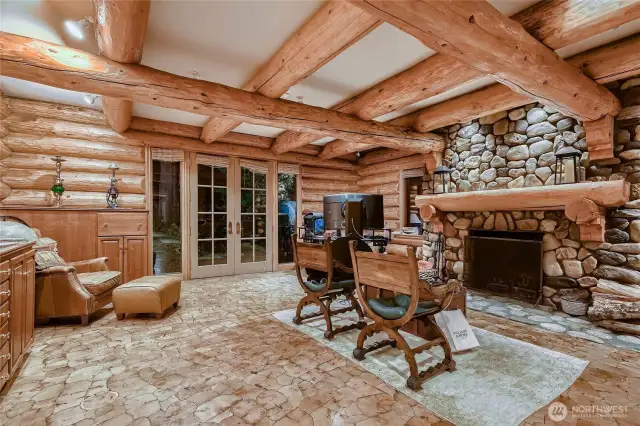 Owner's retreat with beautiful inlaid wood flooring and river rock fireplace.
