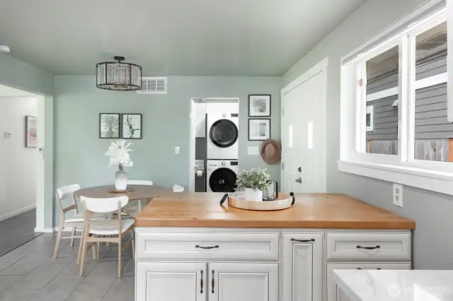A butcher block island anchors the space—perfect for bakers and chefs alike. Envision your next culinary masterpiece coming to life here.