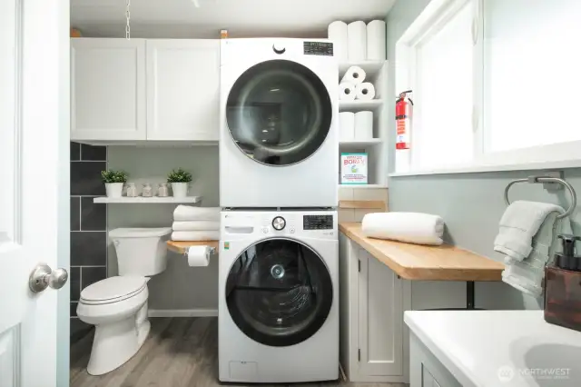 A guest-friendly bathroom and functional utility room are thoughtfully positioned off the kitchen for easy access and daily use.